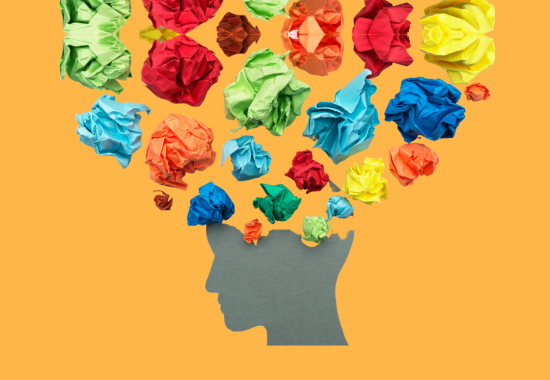 Image of a head silhouette with colorful crumbled papers raising above it
