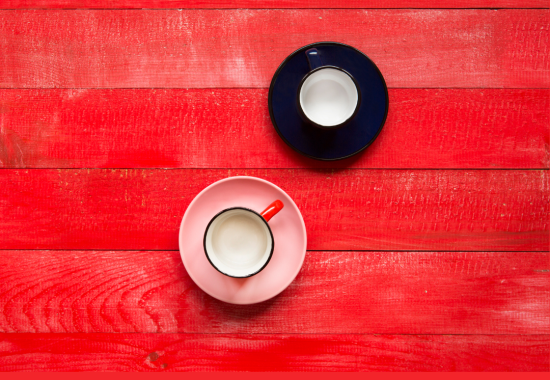 two empty coffee cups on a red background