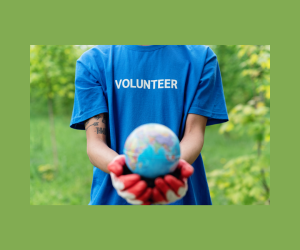 Image of a person wearing a volunteer shirt holding out a globe toward the camera