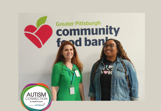 Tammi and Tanaya standing in front of the Community Food Bank sign