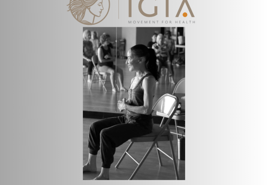 Gia sitting on a chair instructing a class